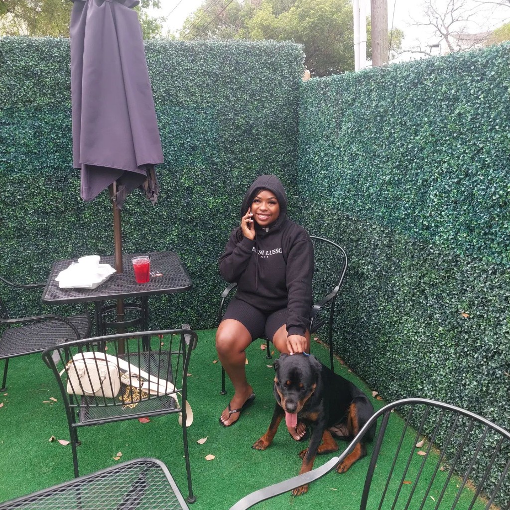 Outdoor patio dining area with greenery and comfortable seating